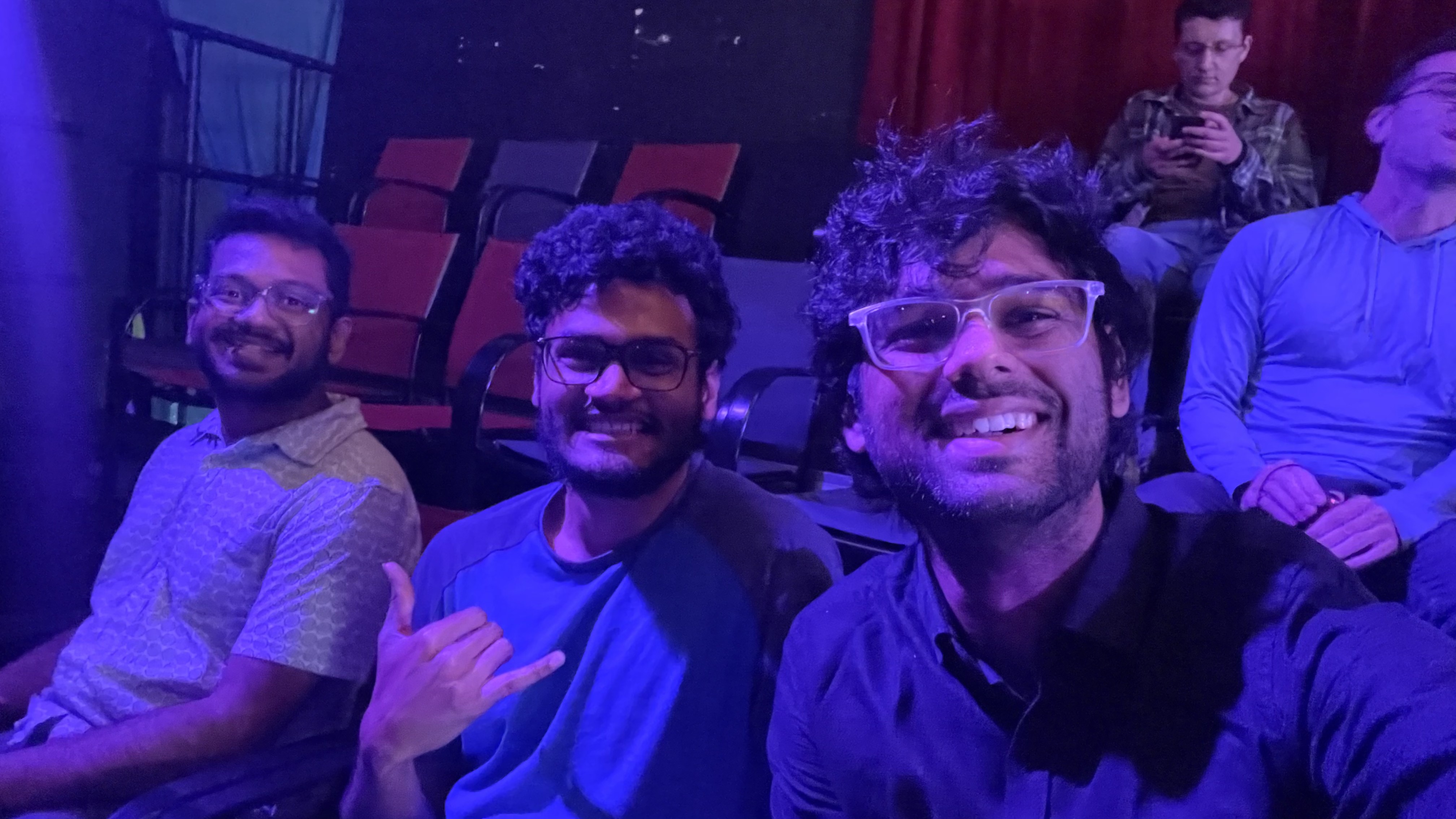 An evening out with friends, sitting together under purple lights.